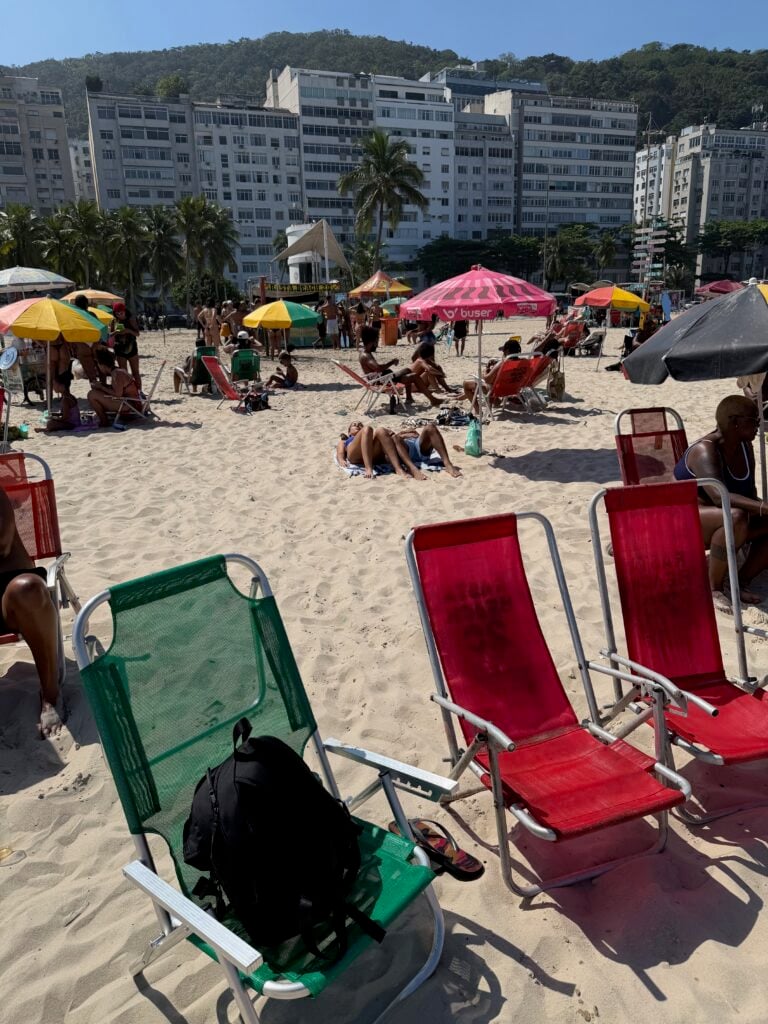 Beach chairs, umbrellas and beachfront buildings at Leme